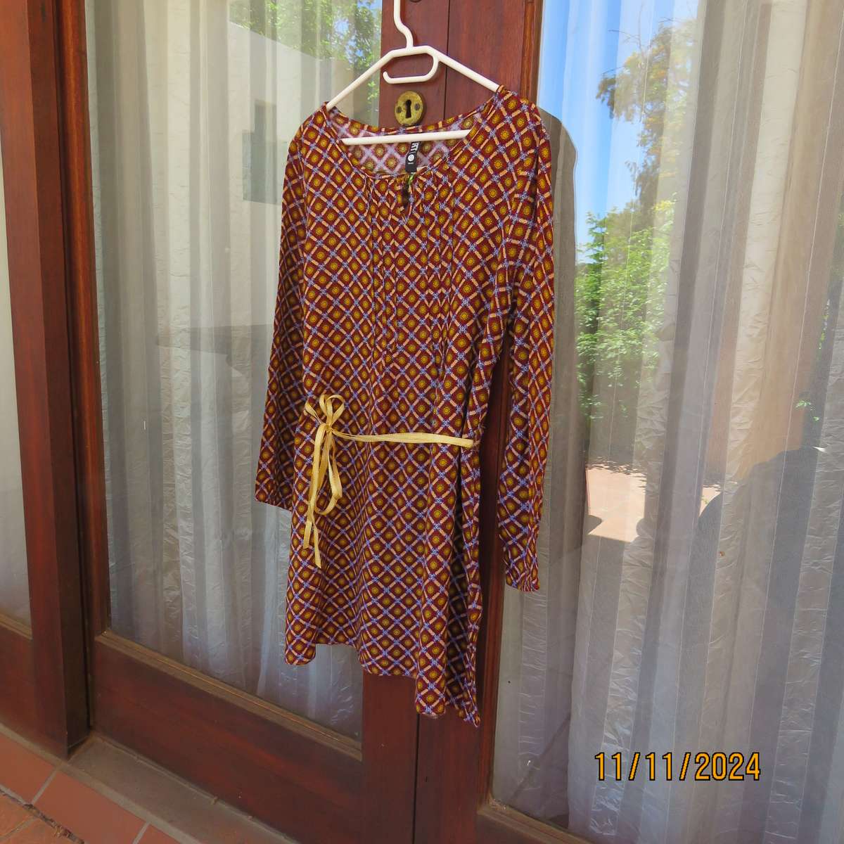 Pretty long sleeve loose  slip over dress in autumn colours.By RT for 11 to 12 yr old. In viscose.