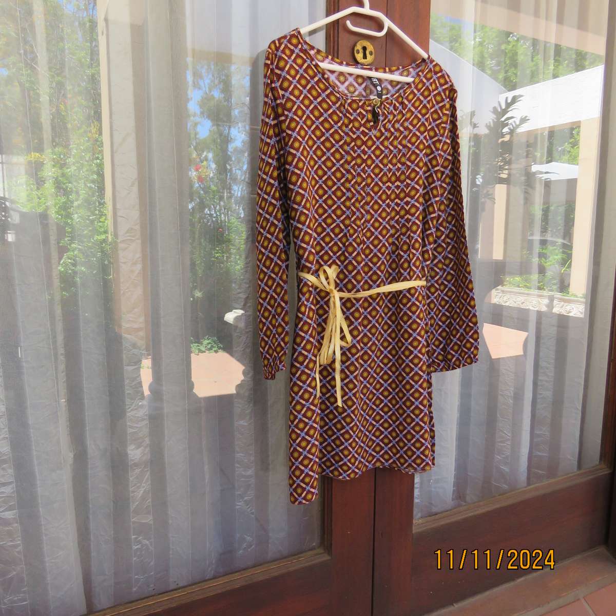 Pretty long sleeve loose  slip over dress in autumn colours.By RT for 11 to 12 yr old. In viscose.
