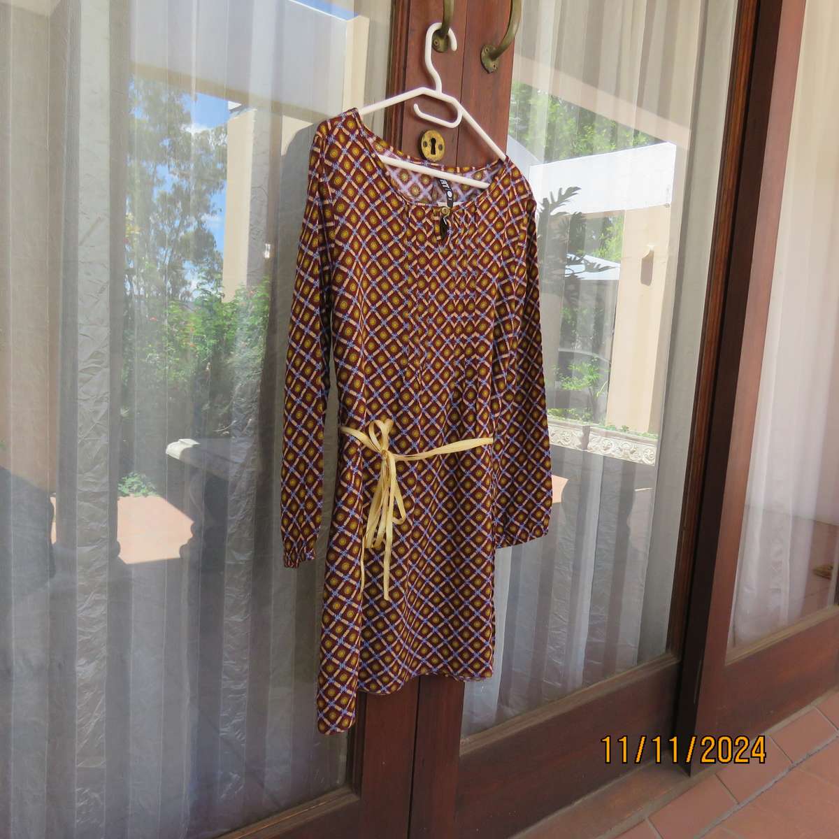 Pretty long sleeve loose  slip over dress in autumn colours.By RT for 11 to 12 yr old. In viscose.