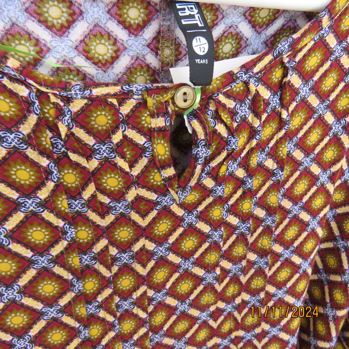 Pretty long sleeve loose  slip over dress in autumn colours.By RT for 11 to 12 yr old. In viscose.