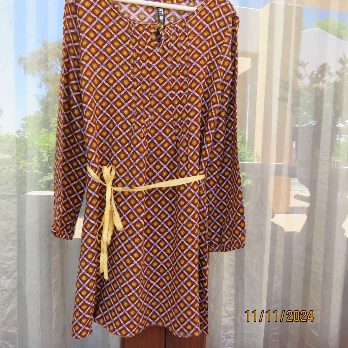Pretty long sleeve loose  slip over dress in autumn colours.By RT for 11 to 12 yr old. In viscose.