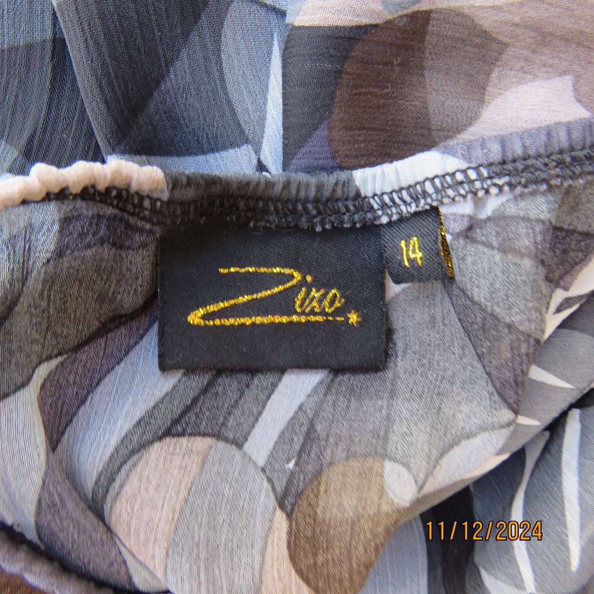 Smart halter neck top by ZIXA size 38 in black-grey-white floral poly-georgette. Black sequin band.