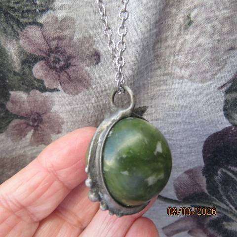 Canadian Jade round polished gemstone pendant in bezel setting with silvery chain