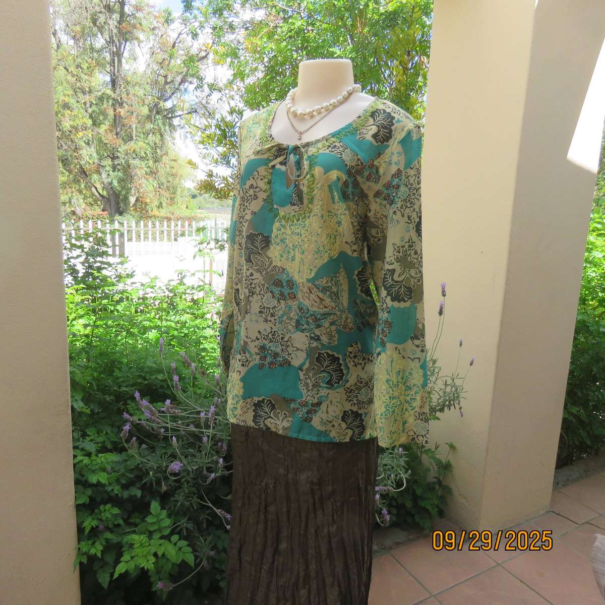 Colourful long sleeve polyester top with green bead decoration. Size 36
