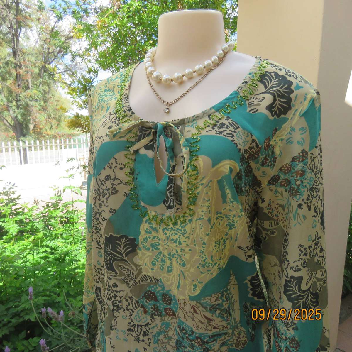 Colourful long sleeve polyester top with green bead decoration. Size 36