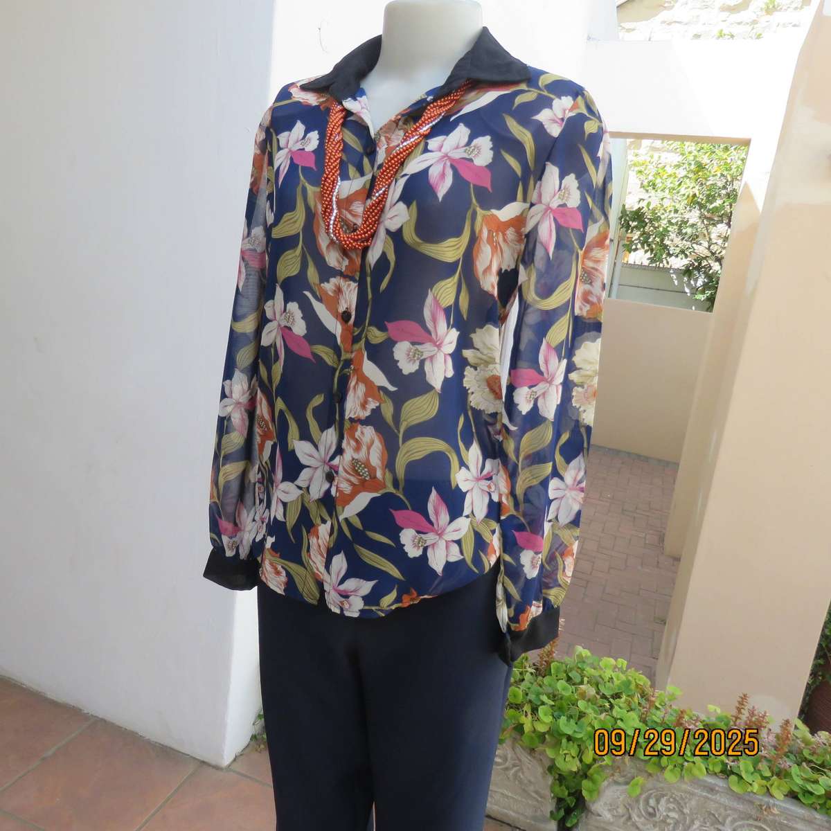 Navy sheer polyester button down top with rust-pink lilies. Black collar-cuffs. Size 36