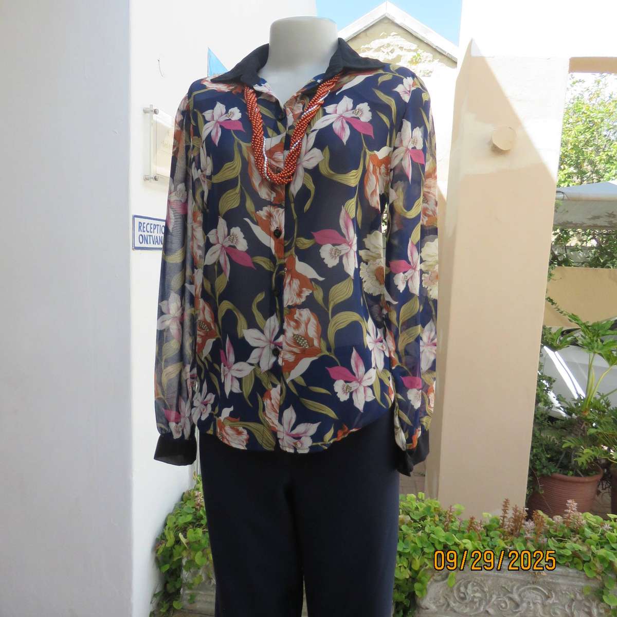Navy sheer polyester button down top with rust-pink lilies. Black collar-cuffs. Size 36