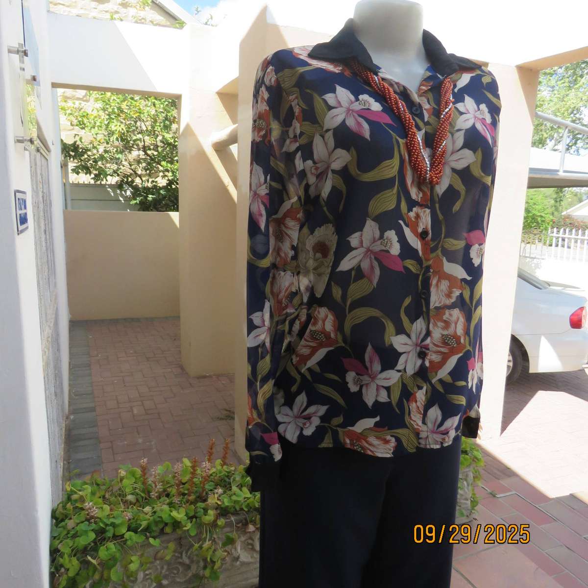 Navy sheer polyester button down top with rust-pink lilies. Black collar-cuffs. Size 36