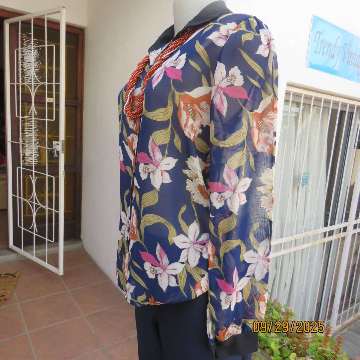 Navy sheer polyester button down top with rust-pink lilies. Black collar-cuffs. Size 36