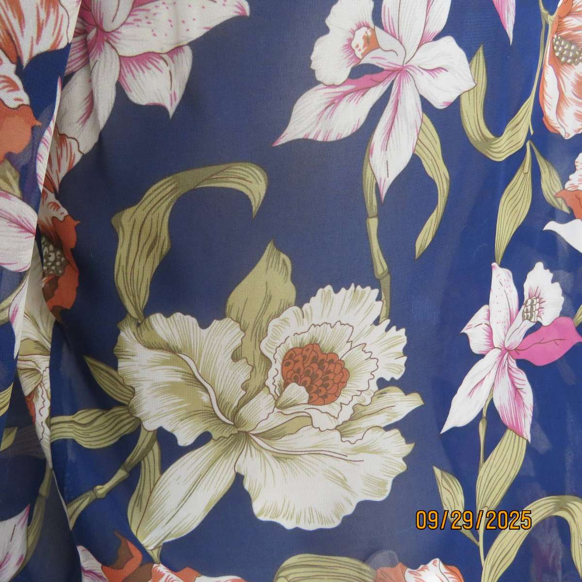 Navy sheer polyester button down top with rust-pink lilies. Black collar-cuffs. Size 36