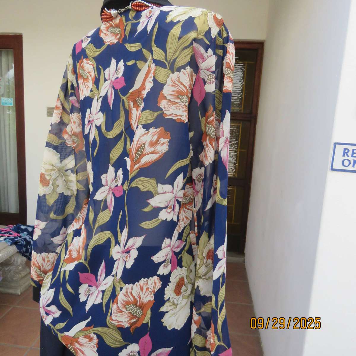 Navy sheer polyester button down top with rust-pink lilies. Black collar-cuffs. Size 36