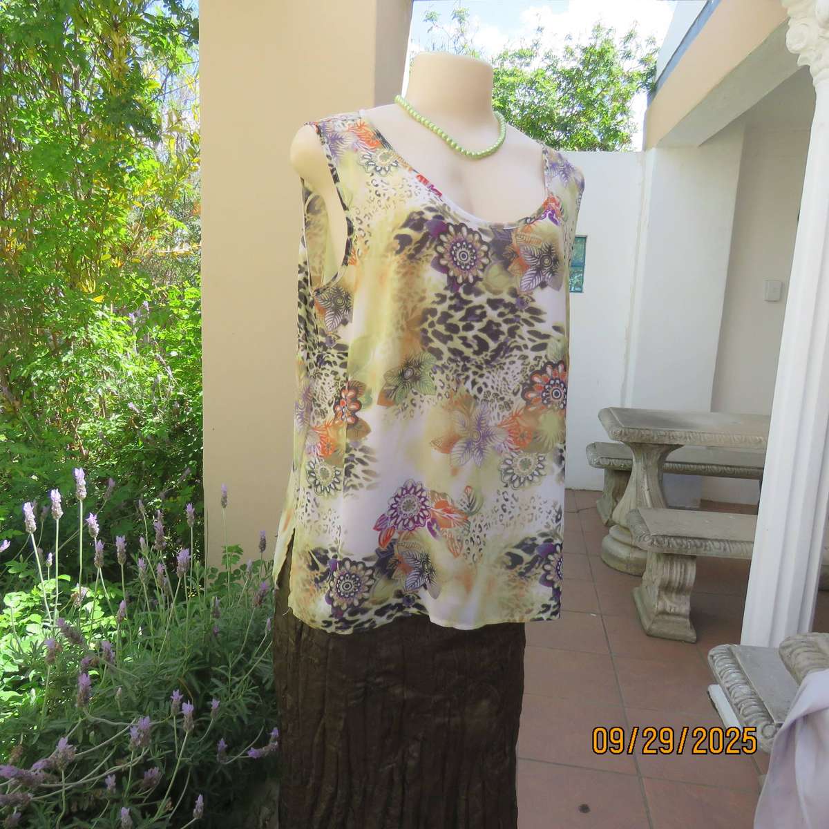 Pale green sleeveless sheer polyester top with orange-purple-black print. Front underlay. Size 42
