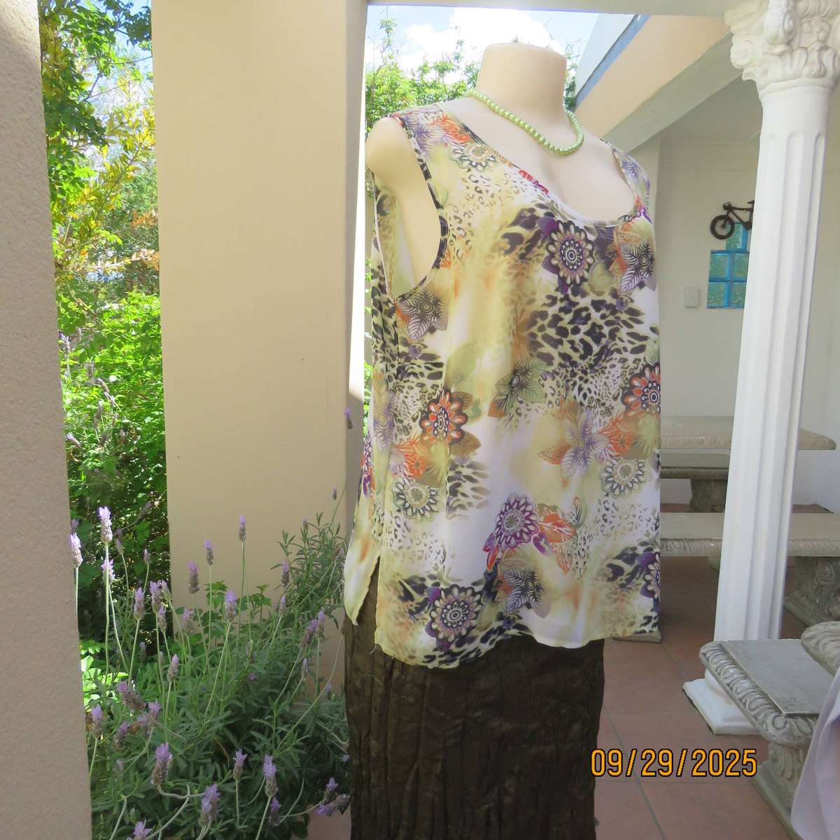 Pale green sleeveless sheer polyester top with orange-purple-black print. Front underlay. Size 42