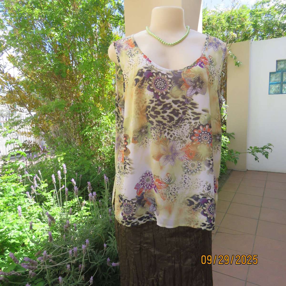 Pale green sleeveless sheer polyester top with orange-purple-black print. Front underlay. Size 42