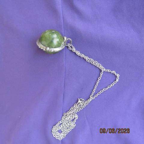 Canadian Jade round polished gemstone pendant in bezel setting with silvery chain