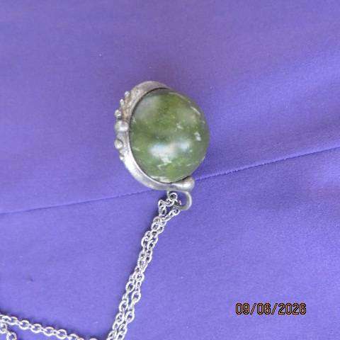 Canadian Jade round polished gemstone pendant in bezel setting with silvery chain