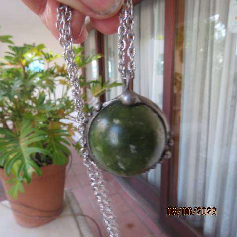 Canadian Jade round polished gemstone pendant in bezel setting with silvery chain