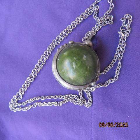 Canadian Jade round polished gemstone pendant in bezel setting with silvery chain