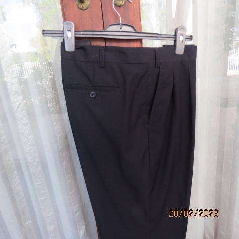 WOOLWORTHS black pleated front dress pants with side and back pockets, size 42