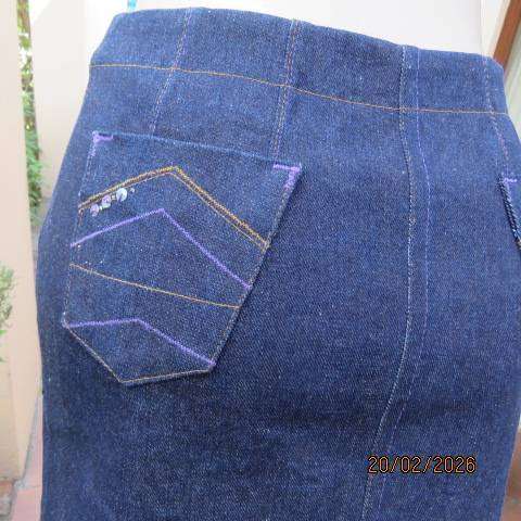 Boutique made 100% blue denim mini jean skirt with cargo front pockets. Size 32
