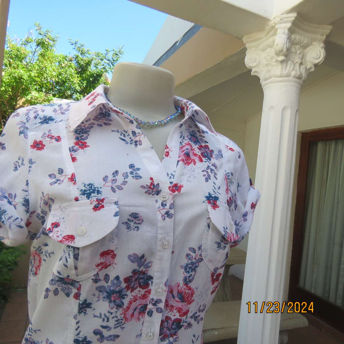 Charming tailored capped sleeve fine cotton white with red-blue floral posies. Size 36. Open collar.