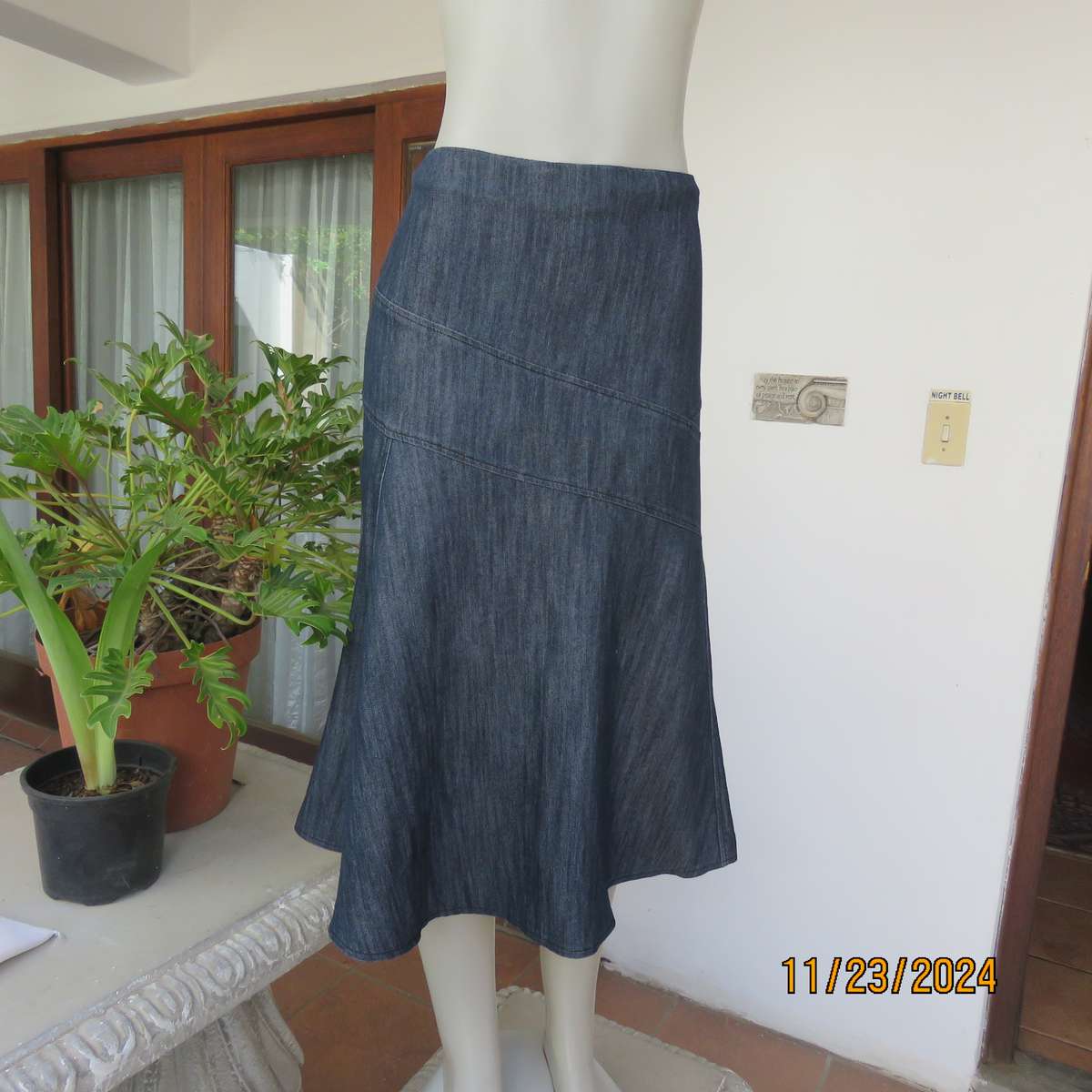 As new dark blue denim jean uniquely paneled kick-out skirt size 44. Bandless. Polycotton stretch.
