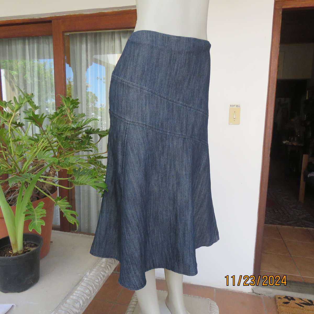 As new dark blue denim jean uniquely paneled kick-out skirt size 44. Bandless. Polycotton stretch.