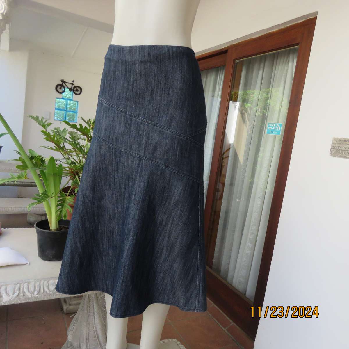 As new dark blue denim jean uniquely paneled kick-out skirt size 44. Bandless. Polycotton stretch.