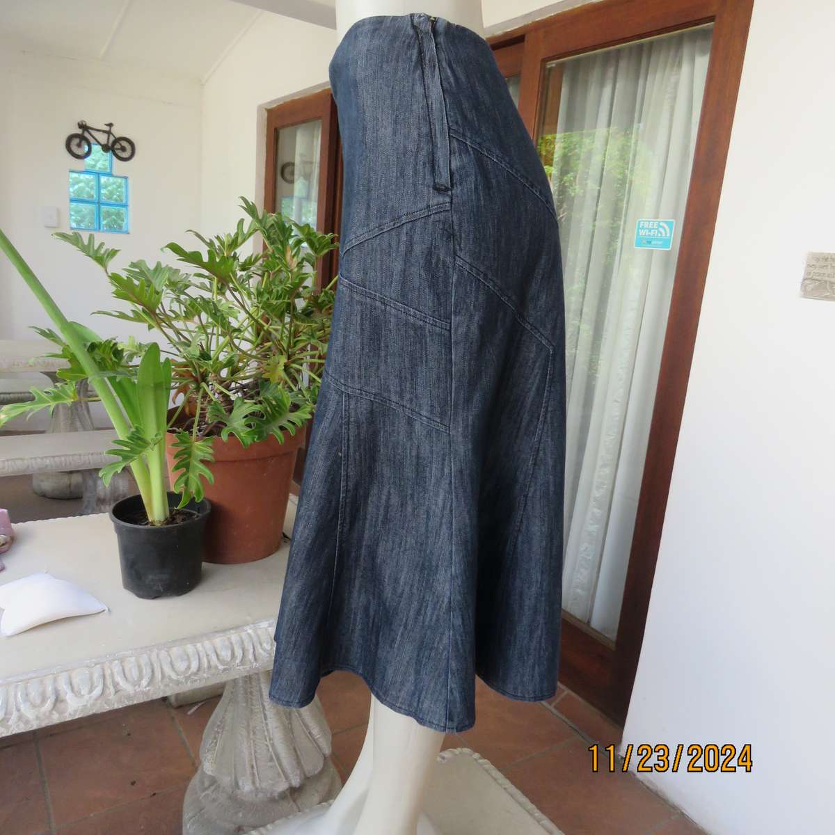 As new dark blue denim jean uniquely paneled kick-out skirt size 44. Bandless. Polycotton stretch.