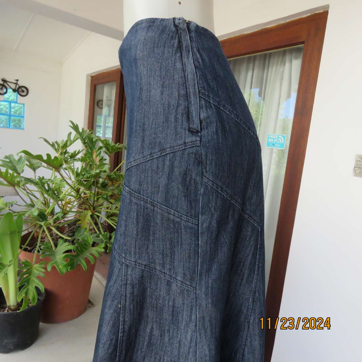 As new dark blue denim jean uniquely paneled kick-out skirt size 44. Bandless. Polycotton stretch.