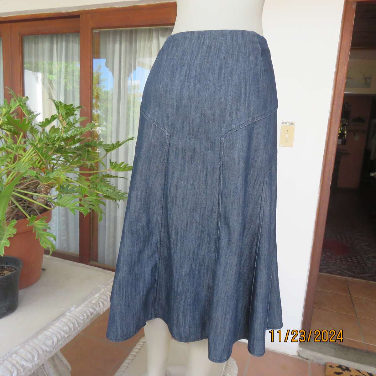 As new dark blue denim jean uniquely paneled kick-out skirt size 44. Bandless. Polycotton stretch.