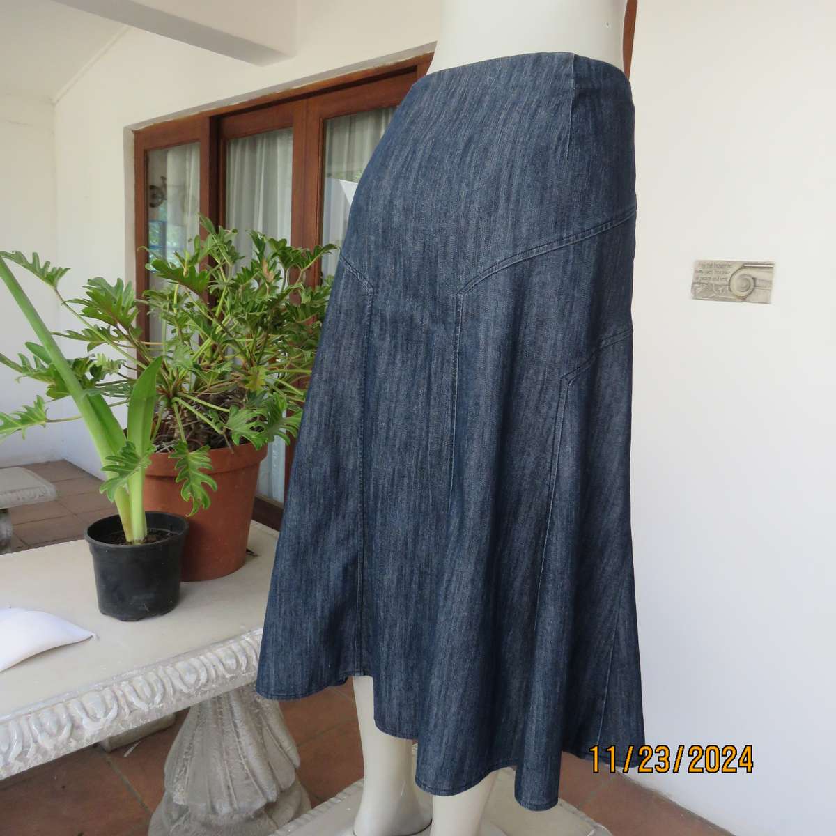 As new dark blue denim jean uniquely paneled kick-out skirt size 44. Bandless. Polycotton stretch.