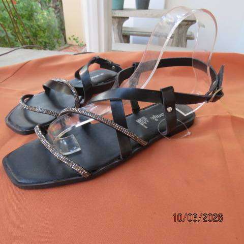 Black flat sandals with ankle strap and glam straps, size 5. Never worn.