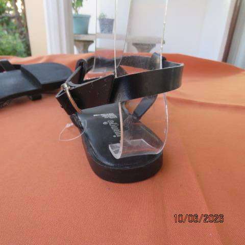 Black flat sandals with ankle strap and glam straps, size 5. Never worn.