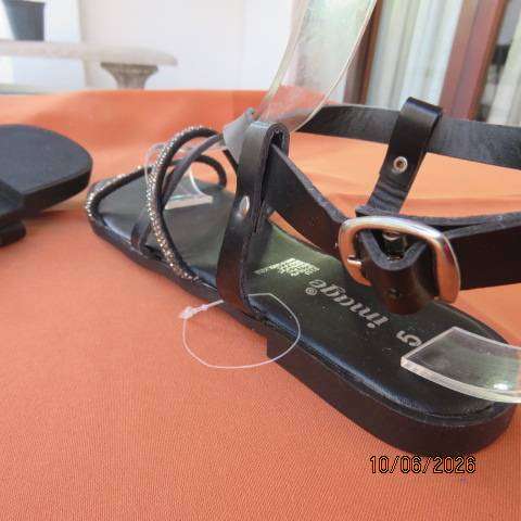Black flat sandals with ankle strap and glam straps, size 5. Never worn.