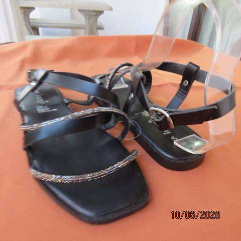 Black flat sandals with ankle strap and glam straps, size 5. Never worn.