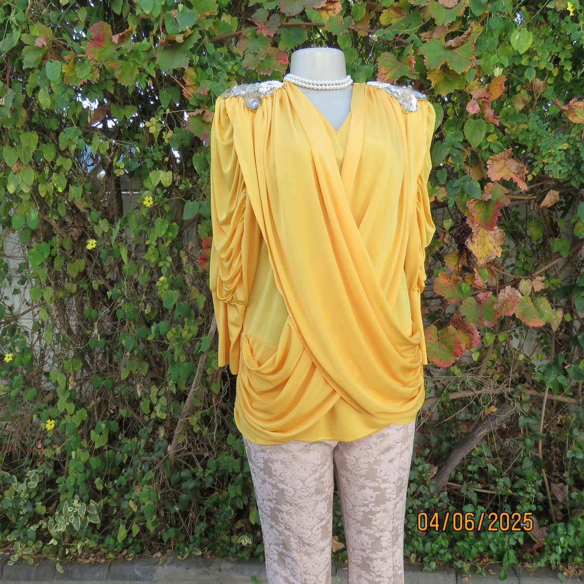 Buttercup yellow unique size 40 stretch polyester top. Crossover overlays. Shoulder decoration.