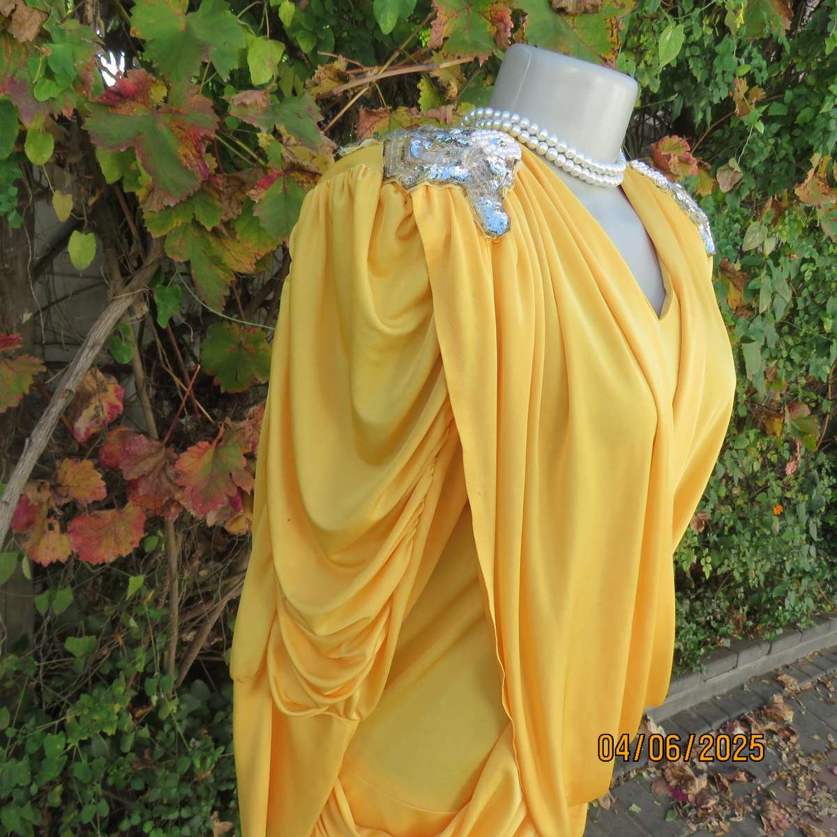 Buttercup yellow unique size 40 stretch polyester top. Crossover overlays. Shoulder decoration.