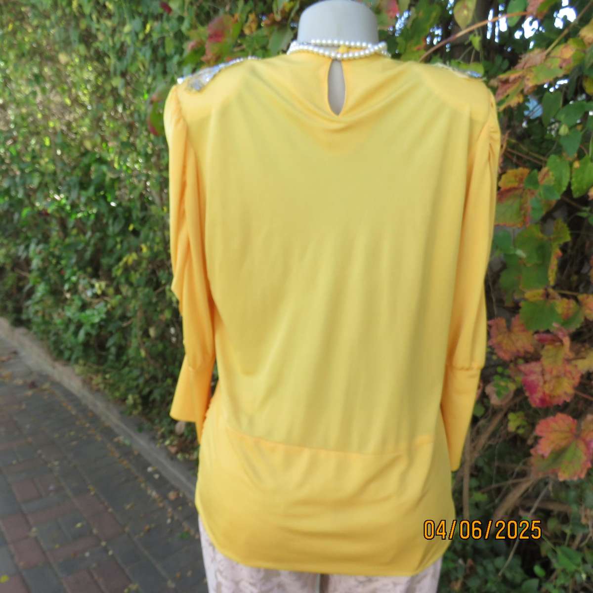 Buttercup yellow unique size 40 stretch polyester top. Crossover overlays. Shoulder decoration.