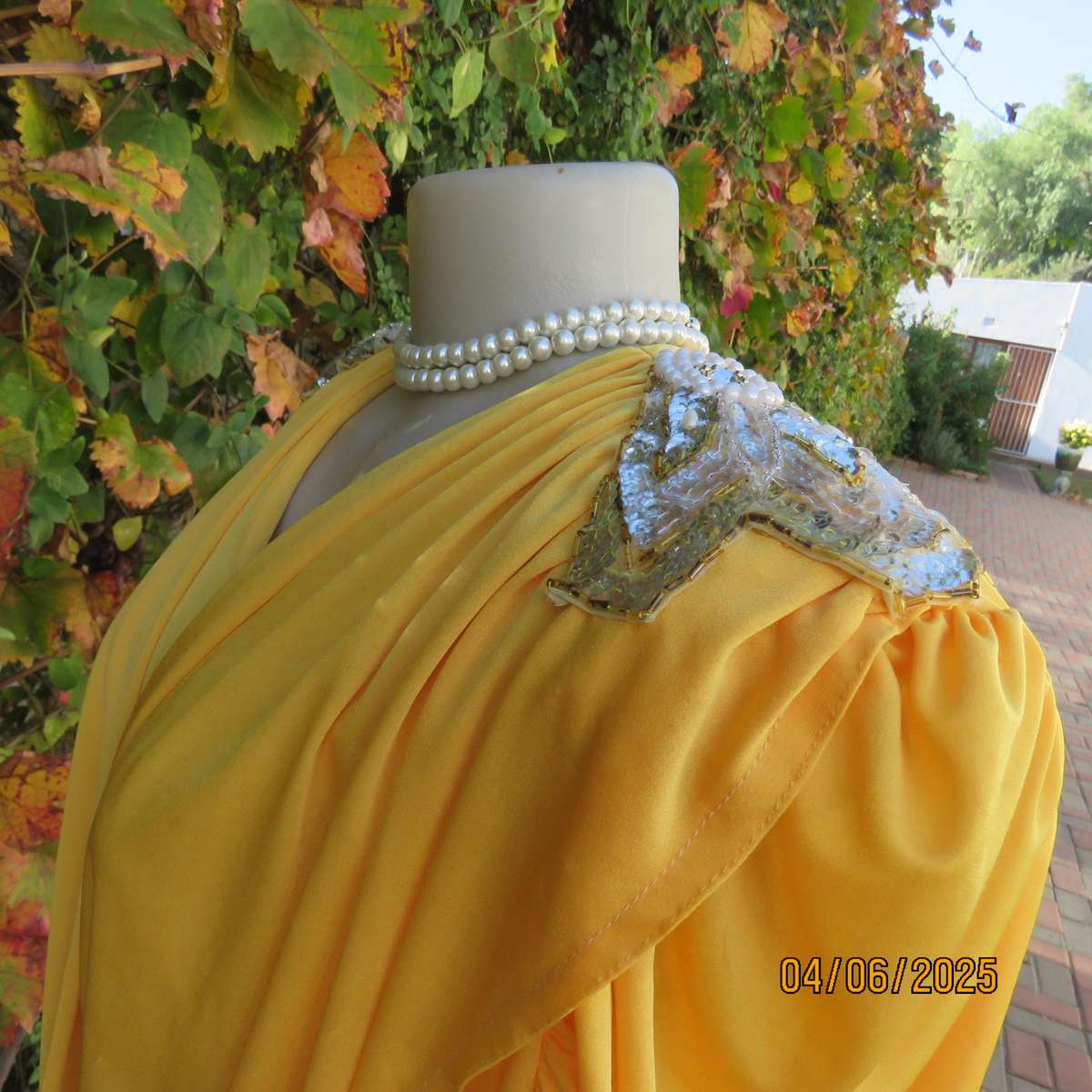 Buttercup yellow unique size 40 stretch polyester top. Crossover overlays. Shoulder decoration.