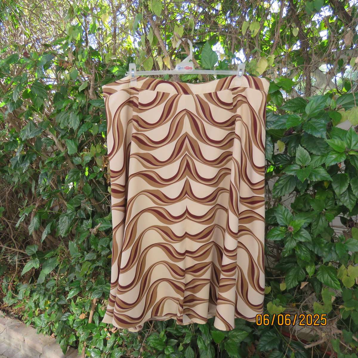 Graphic printed rich cream fully lined polyester A-Line skirt. Brown-tan print. Size 50