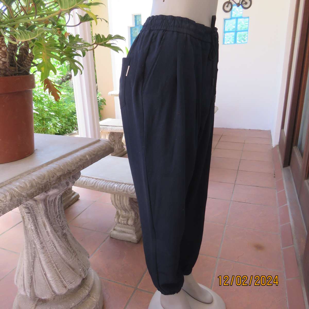 Comfy wide cut navy polyester pants size 38. Front pleats.Elasticated waist -leg hems. Drawstring.