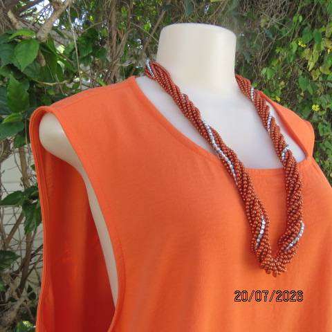 Orange sleeveless slip-over slightly creased polyester dress with frill bottom, size 44-46