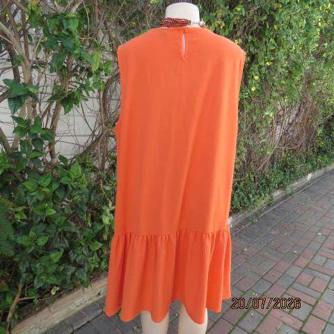Orange sleeveless slip-over slightly creased polyester dress with frill bottom, size 44-46