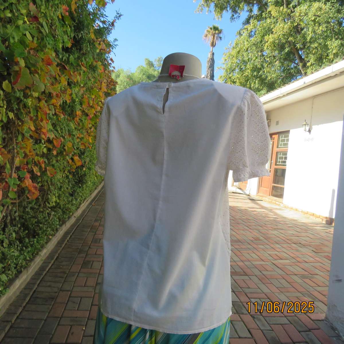 White cotton slip over top. Front and sleeves with eyelet embroidery. Size 36