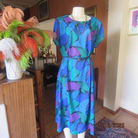 Violet-green-blue with black accents polyester slip over size 44-46 dress.