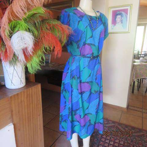 Violet-green-blue with black accents polyester slip over size 44-46 dress.