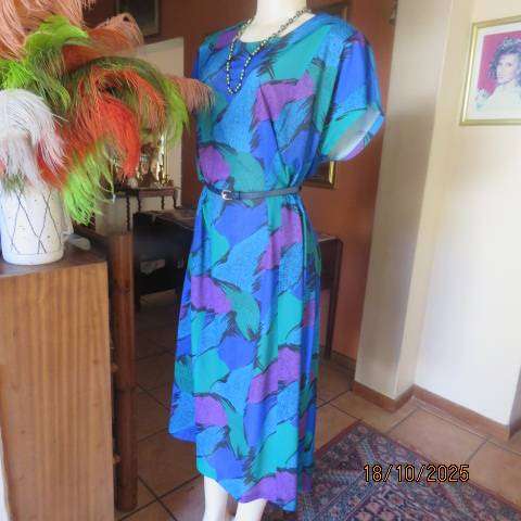 Violet-green-blue with black accents polyester slip over size 44-46 dress.