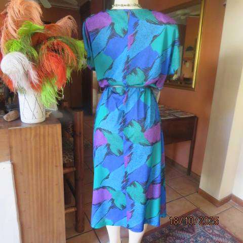 Violet-green-blue with black accents polyester slip over size 44-46 dress.