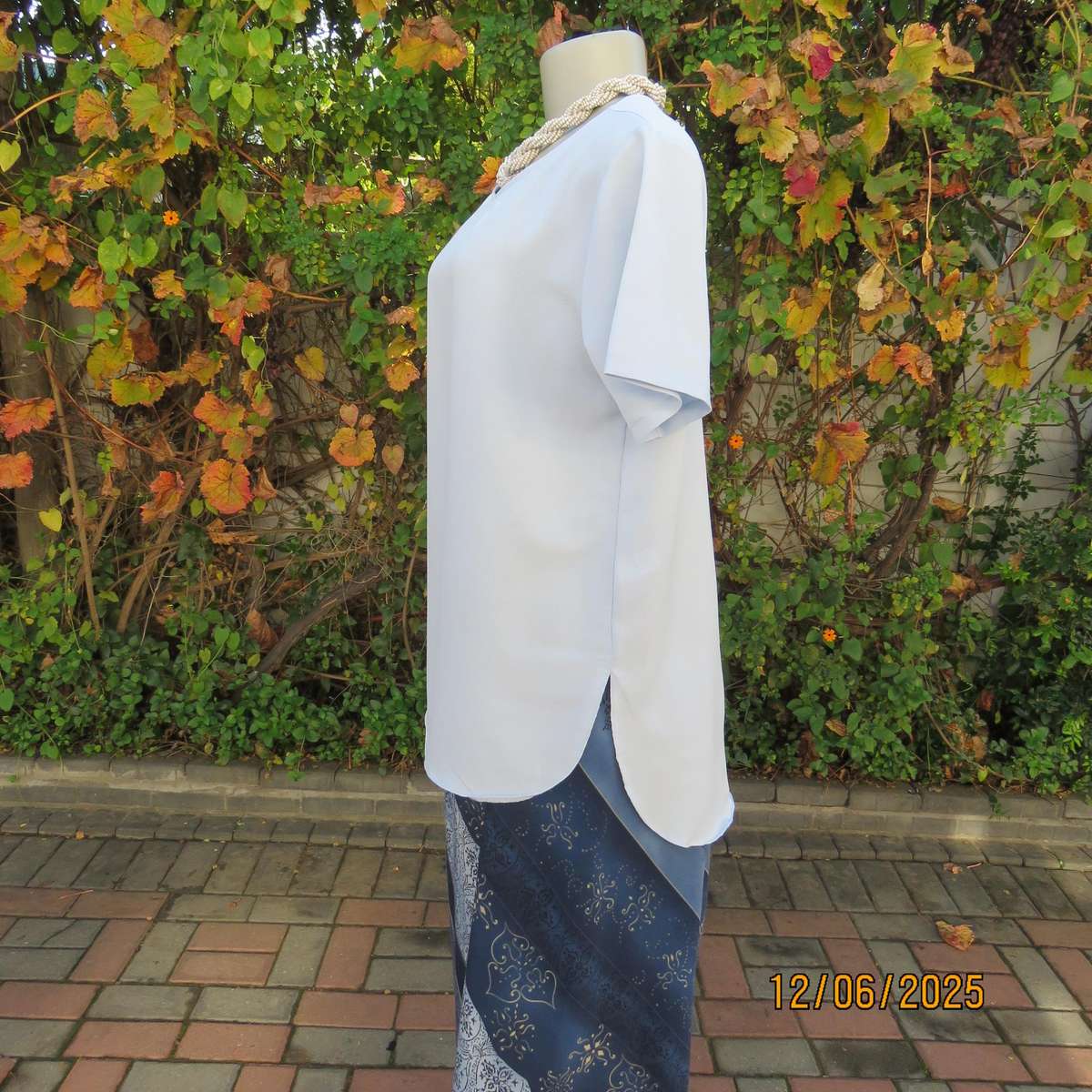 Light blue textured polyester slip over short sleeve top. Size 34. As new